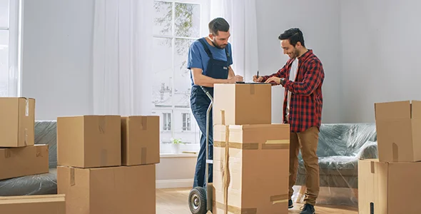Movers shifting furniture during internal moving services in Elkhart, IN.